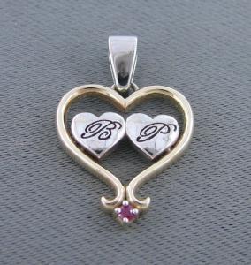 Gold heart pendant with initials and ruby